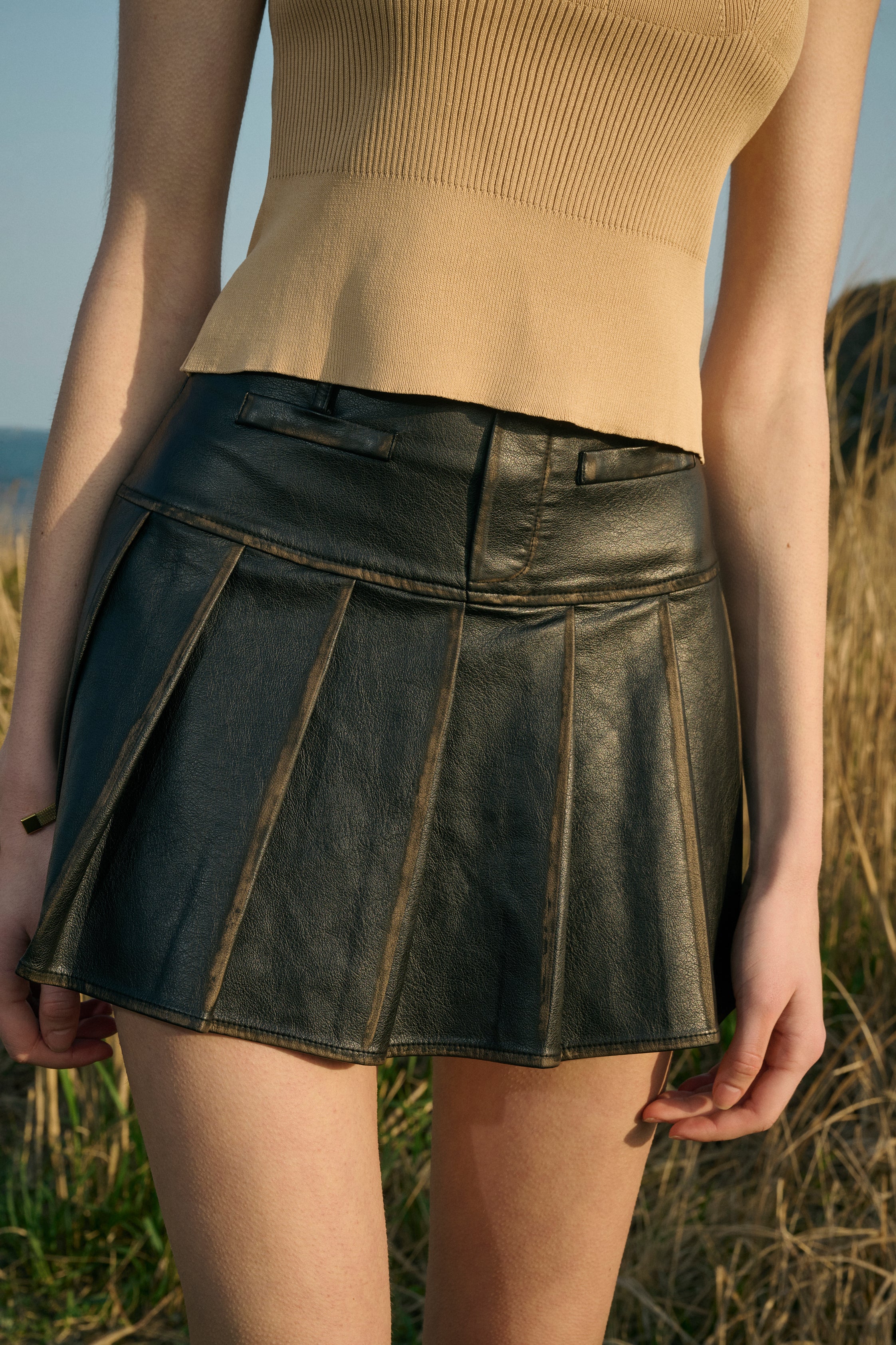 Distressed pleated mini skirt